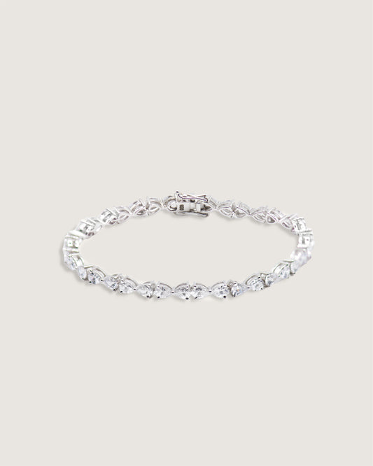 Dewdrop Inverted Pear Tennis Bracelet — alternating inverted pear-cut and round stones, studio product shot on grey background — Stone Symphony