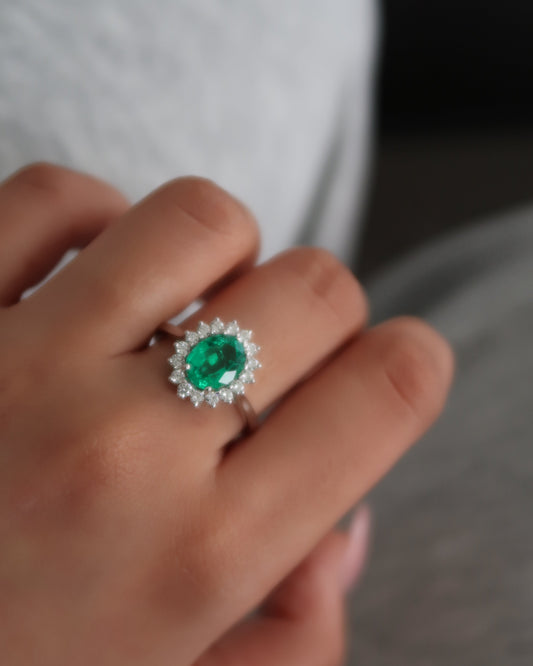 Sunburst Halo Ring in Emerald close-up — oval emerald and diamond halo detail — Stone Symphony