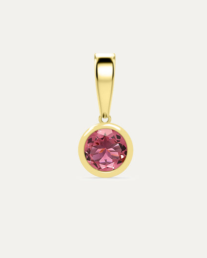 Aurelle Bezel Birthstone Charm in Pink Tourmaline — soft pink tourmaline bezel-set in yellow gold with polished bail, studio product shot — Stone Symphony