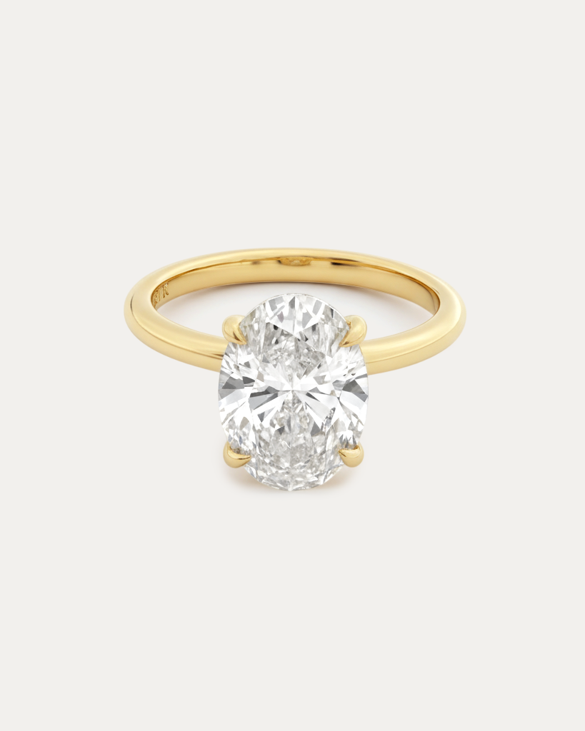 Oval Solitaire Diamond Ring — large oval-cut diamond in 4-prong yellow gold solitaire setting, studio product shot — Stone Symphony