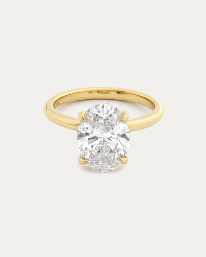 Oval Solitaire Diamond Ring — large oval-cut diamond in 4-prong yellow gold solitaire setting, studio product shot — Stone Symphony