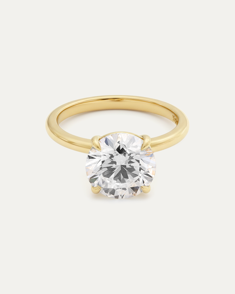 Brilliant Round Diamond Solitaire Ring — large round brilliant diamond in 4-prong yellow gold setting, studio product shot — Stone Symphony