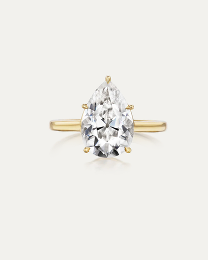 Pear Diamond Solitaire Ring — large pear-cut diamond in yellow gold multi-prong setting, studio product shot — Stone Symphony