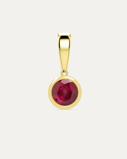 Aurelle Bezel Birthstone Charm in Ruby — deep red ruby bezel-set in yellow gold with polished bail, studio product shot — Stone Symphony