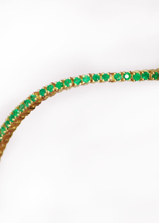 Grace Emerald Tennis Bracelet on wrist — green emerald stones in yellow gold — Stone Symphony