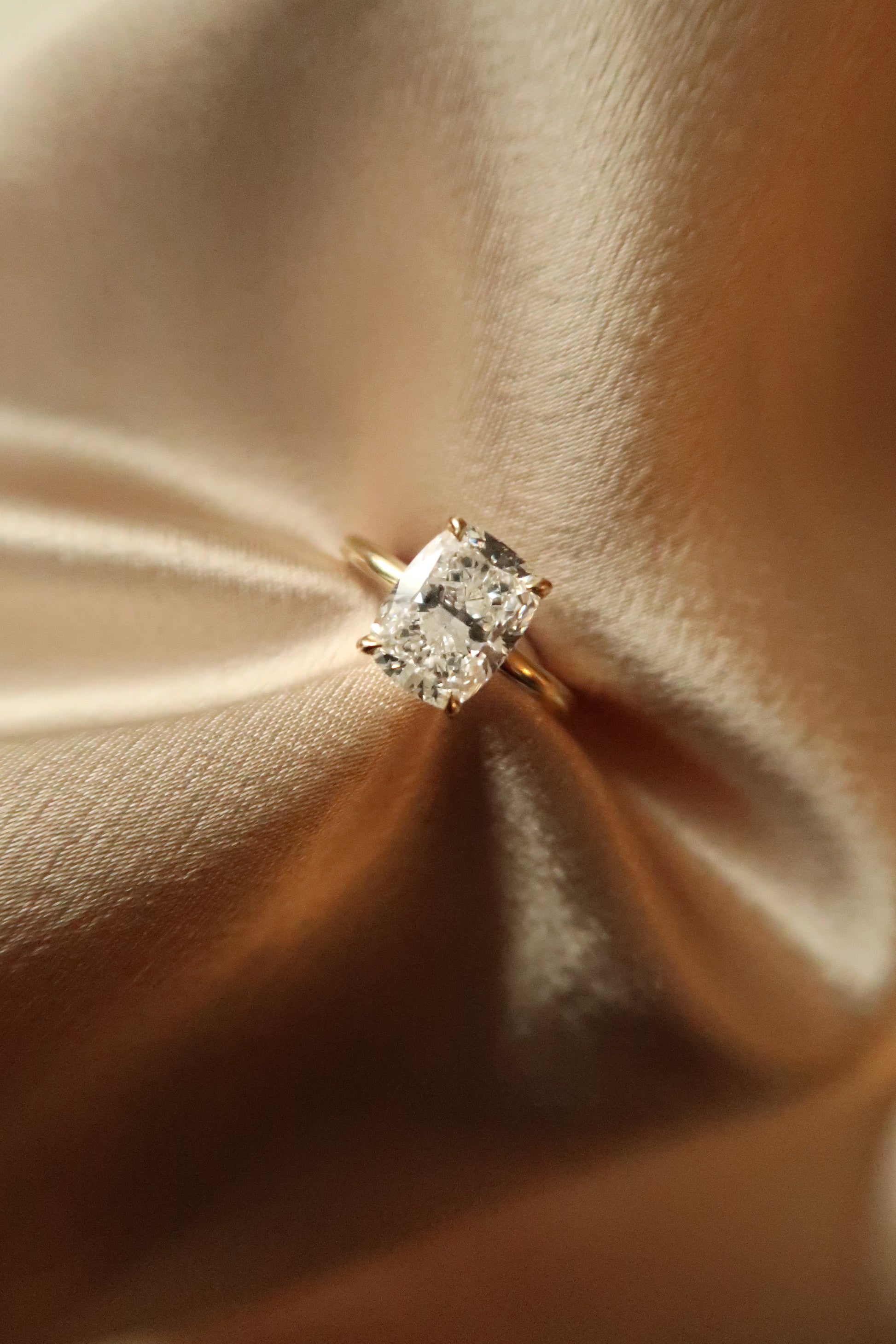 Elongated Cushion Diamond Solitaire Ring worn on finger — yellow gold solitaire — Stone Symphony