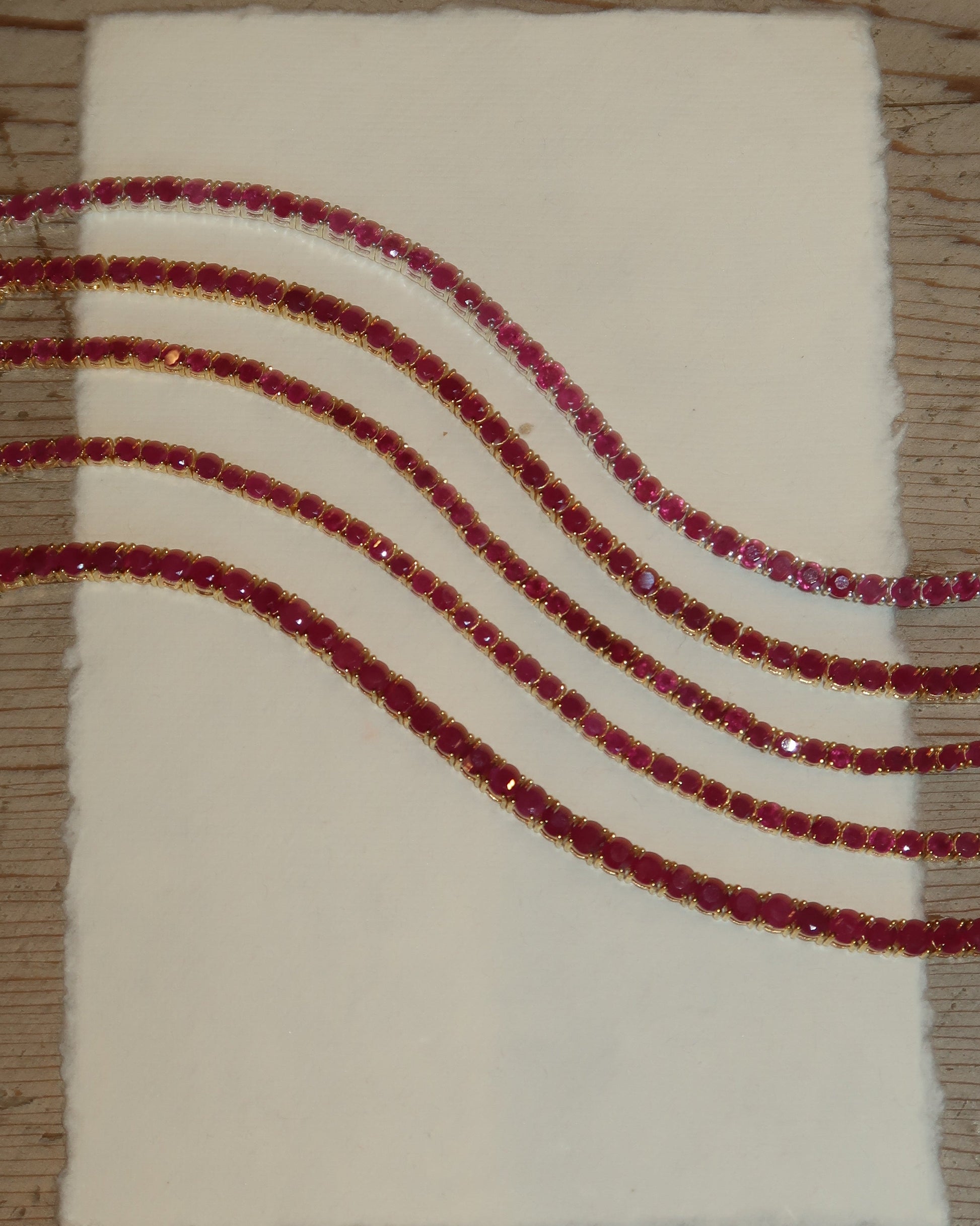 Classic Ruby Tennis Bracelet 18K gold vermeil on wrist — deep red ruby stones — Stone Symphony