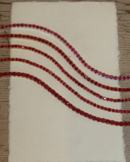 Classic Ruby Tennis Bracelet 18K gold vermeil on wrist — deep red ruby stones — Stone Symphony