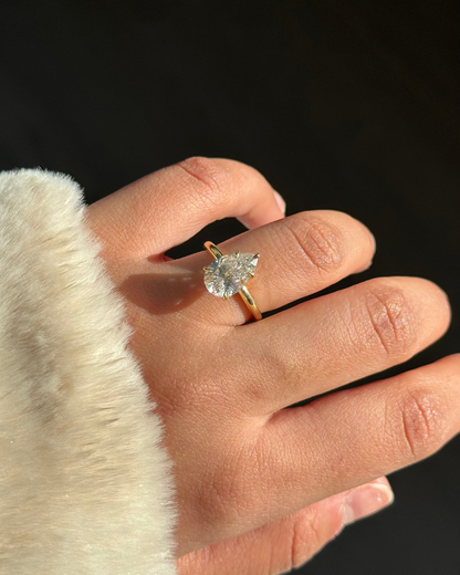 Pear Diamond Solitaire Ring worn on finger — Stone Symphony