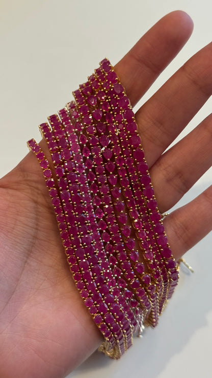 Dewdrop Ruby Tennis Bracelet on wrist — pear-drop ruby stones — Stone Symphony