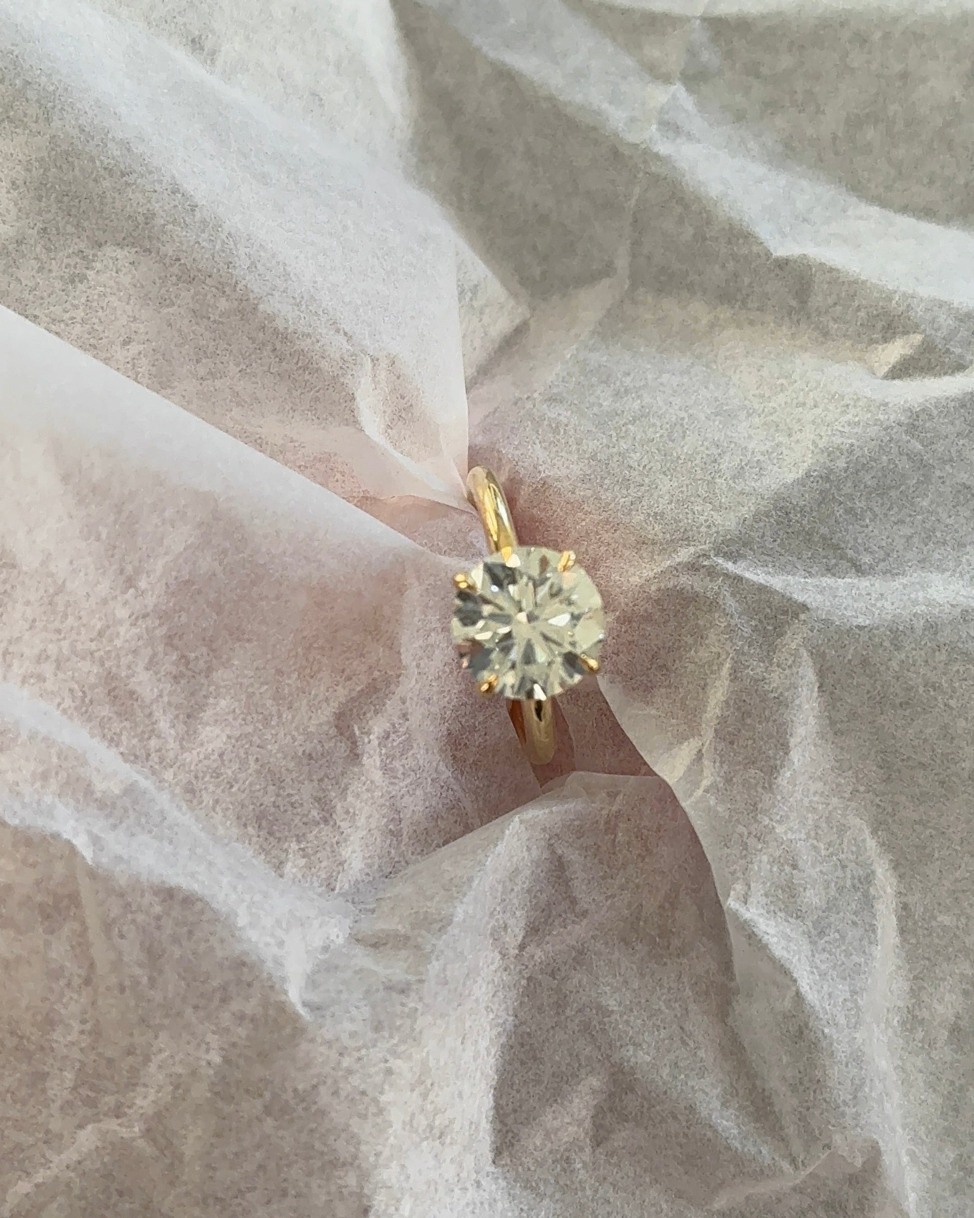 Brilliant Round Diamond Solitaire Ring on finger — yellow gold engagement ring — Stone Symphony