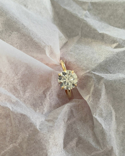Brilliant Round Diamond Solitaire Ring on finger — yellow gold engagement ring — Stone Symphony