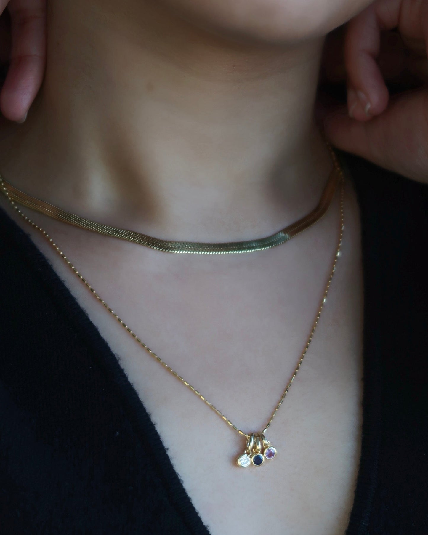 Aurelle Ruby Bezel Charm on model — red ruby stone in yellow gold — Stone Symphony