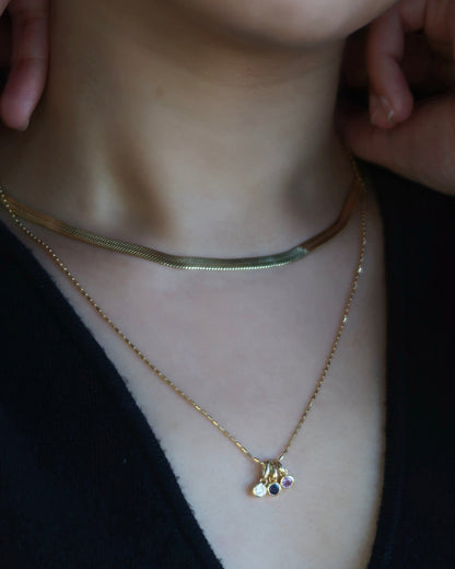 Aurelle Ruby Bezel Charm on model — red ruby stone in yellow gold — Stone Symphony