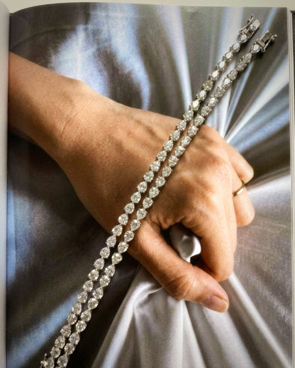 Dewdrop Pear Tennis Bracelet worn on wrist — stacked with round-cut bracelet, outdoor lifestyle — Stone Symphony