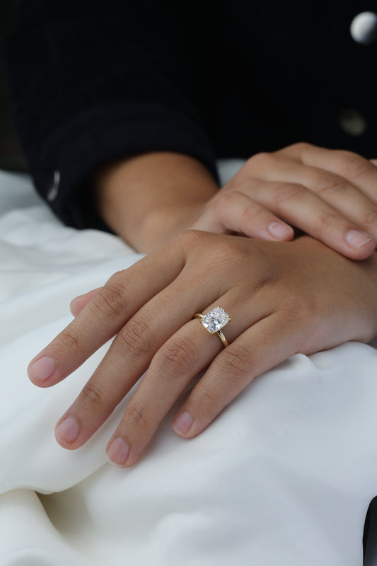 Elongated Cushion Diamond Solitaire Ring on hand — cushion-cut diamond in yellow gold — Stone Symphony